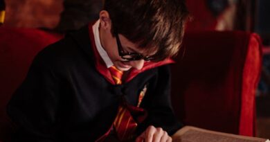 Boy in Black Robe Wearing Black Framed Eyeglasses Reading a Book
