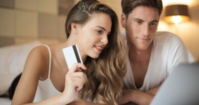 Cheerful couple making online purchases at home