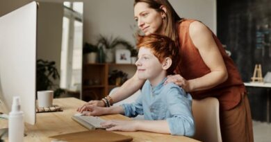 Photo of Woman Teaching His Son While Smiling