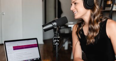 woman in black tank top sitting on chair in front of microphone