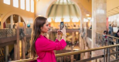 a woman taking a picture of herself in a mall