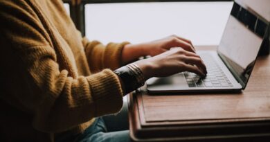 person sitting front of laptop