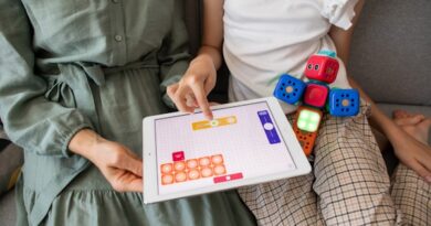 child playing game on white ipad