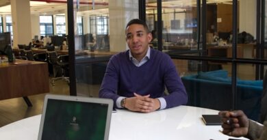 a man sitting at a table with a laptop