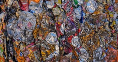 A large amount of soda cans are stacked together